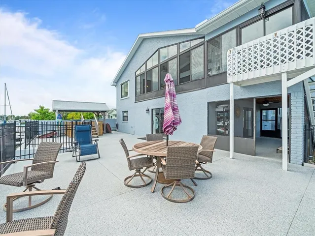 a dining room with furniture a chandelier and window