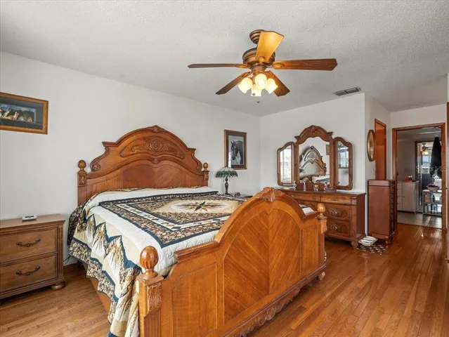 a bedroom with a bed and a chair