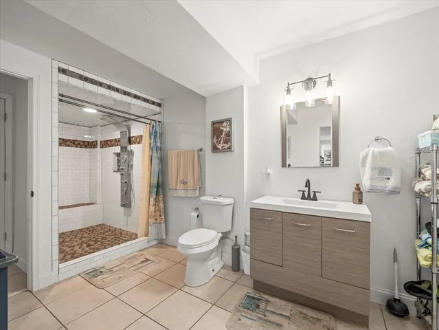 an aerial view of residential houses with outdoor space and lake view