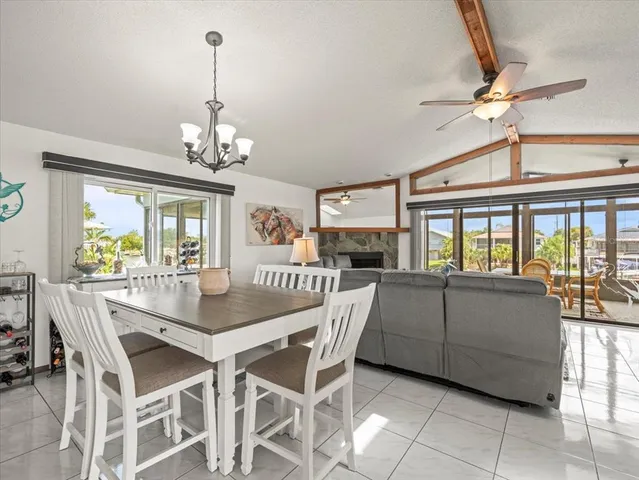 a view of a dining room with furniture and a chandelier