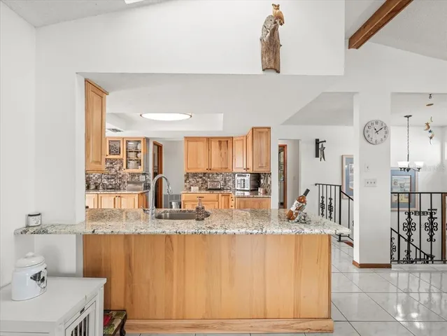 a kitchen with stainless steel appliances a stove a sink and a refrigerator