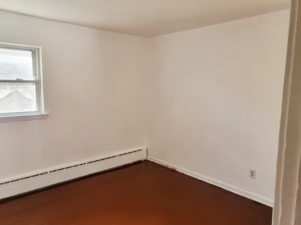 an empty room with wooden floor