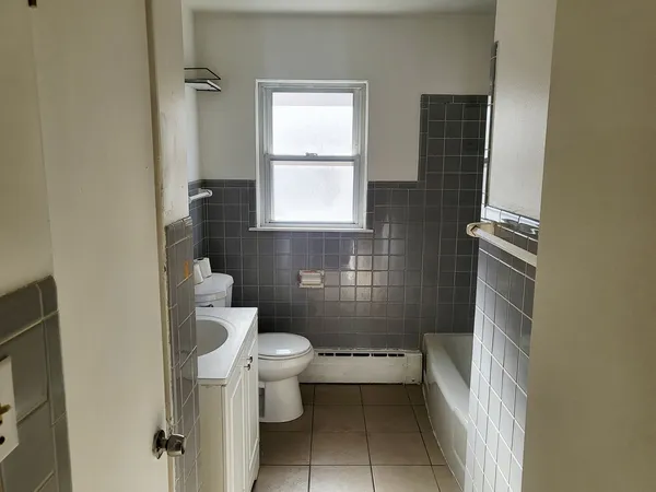 a bathroom with a toilet a sink and bathtub