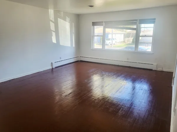 a kitchen with sink cabinets and wooden floor