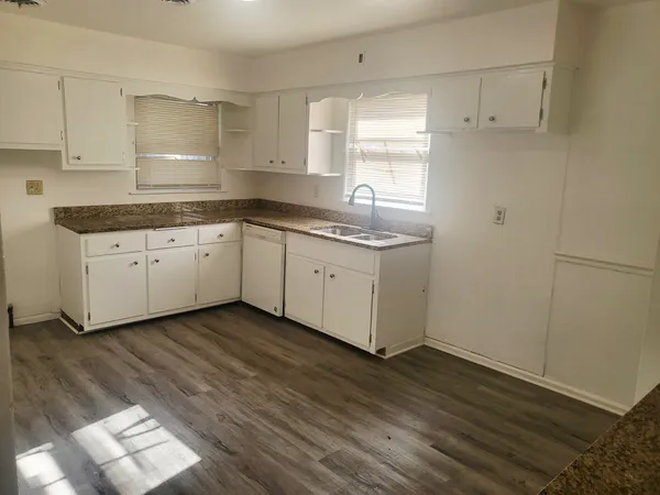 a view of cabinets and wooden floor