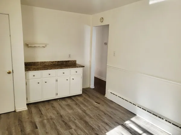 a view of a kitchen with wooden floor