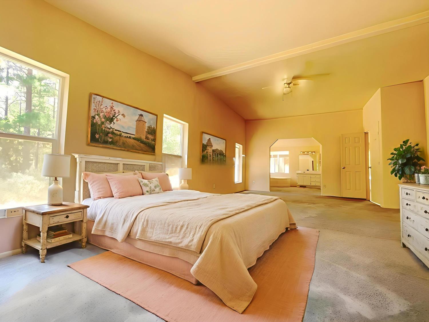 112 Renegade Road Oroville, CA 95966 - Photo 17 of 38 a bedroom with a bed a mirror on dresser and a window