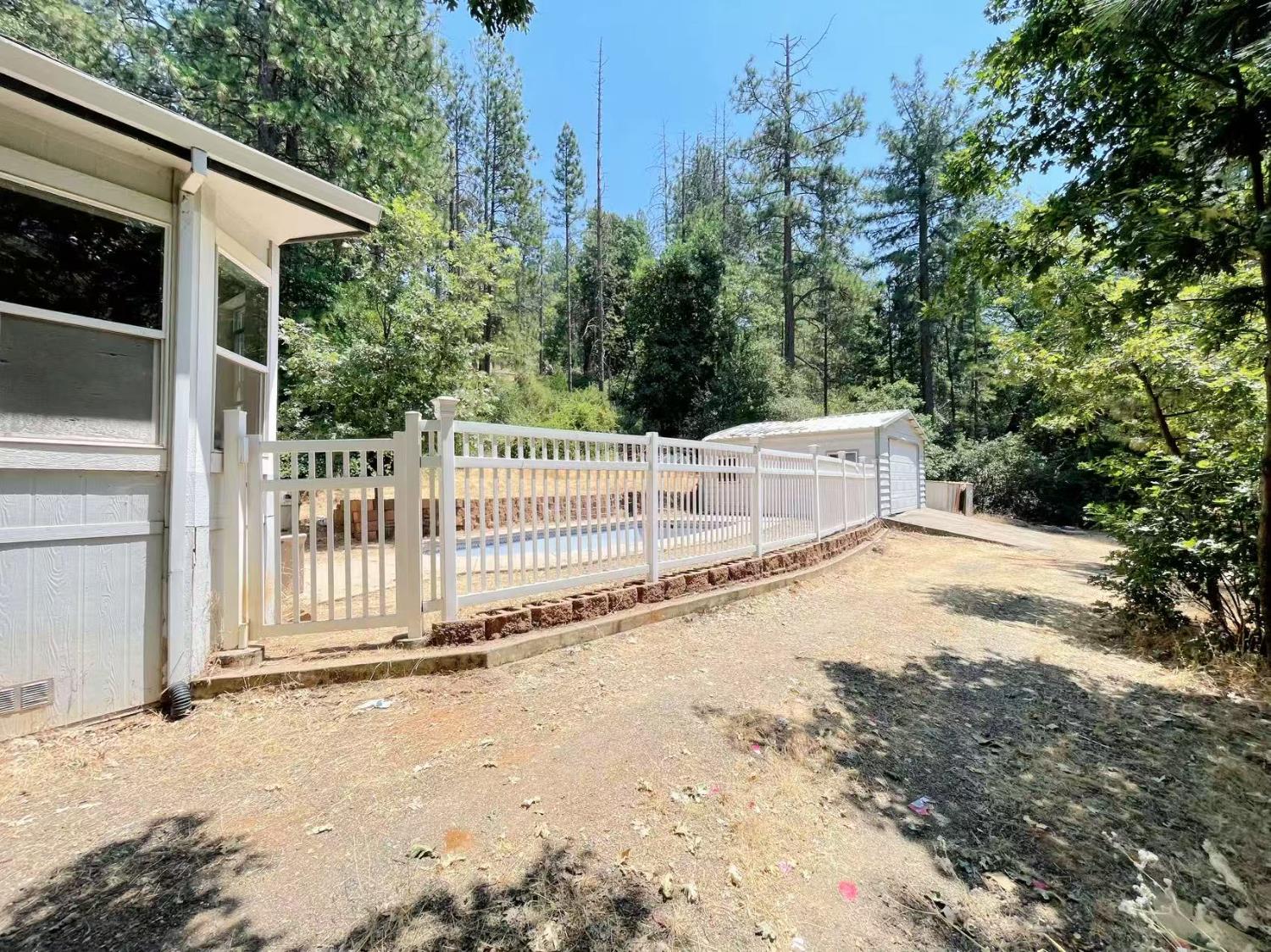112 Renegade Road Oroville, CA 95966 - Photo 5 of 38 a white house that has tree in front of it