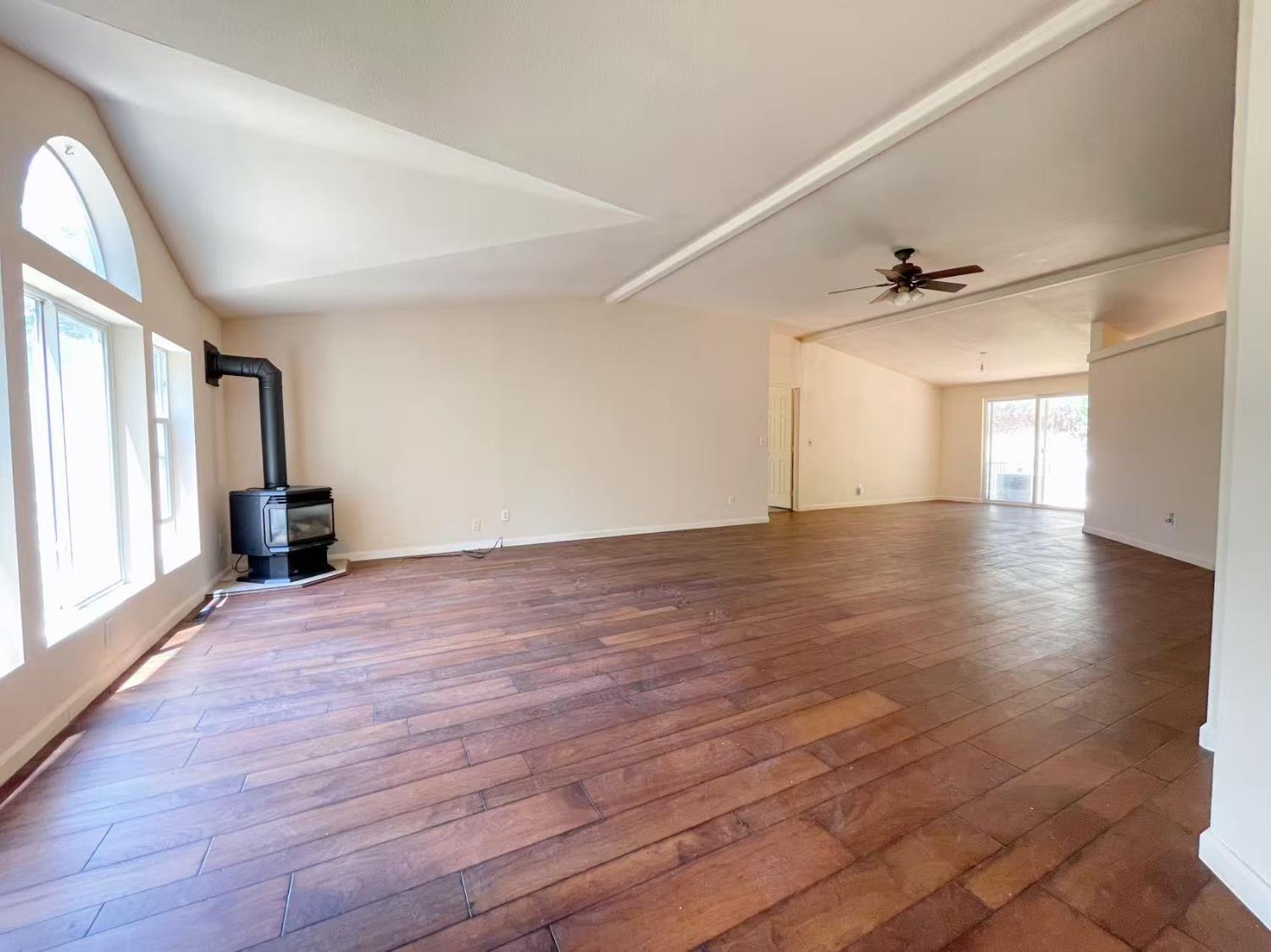 112 Renegade Road Oroville, CA 95966 - Photo 6 of 38 an empty room with wooden floor and windows