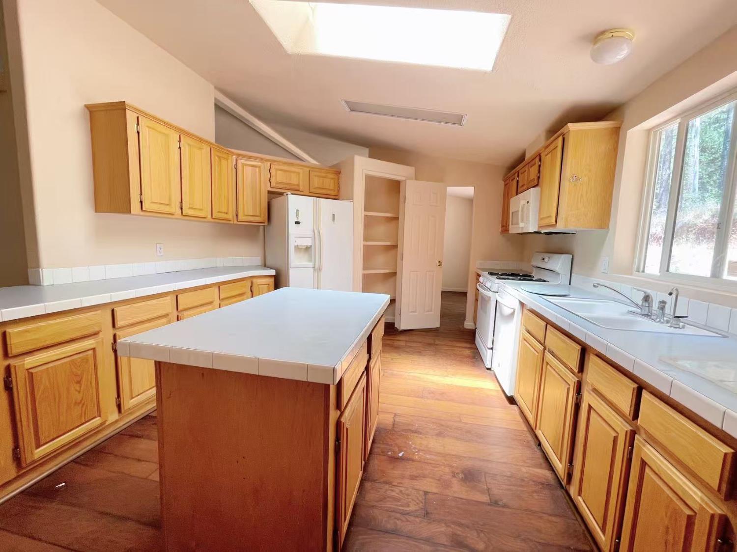 112 Renegade Road Oroville, CA 95966 - Photo 10 of 38 a kitchen with stainless steel appliances a sink a counter top space and cabinets