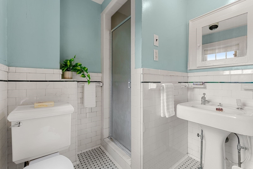 18 Burnside Road Newton, MA 02461 - Photo 17 of 27 a bathroom with a sink a toilet and shower