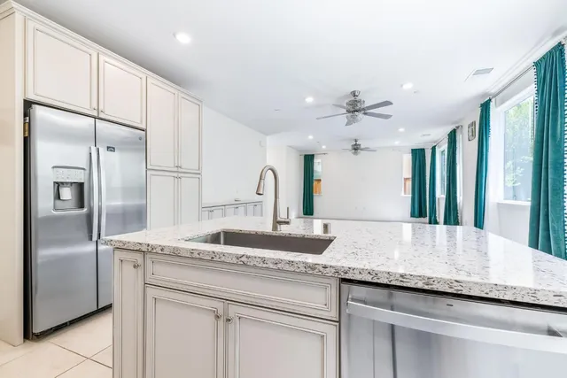 a kitchen with white cabinets and white appliances