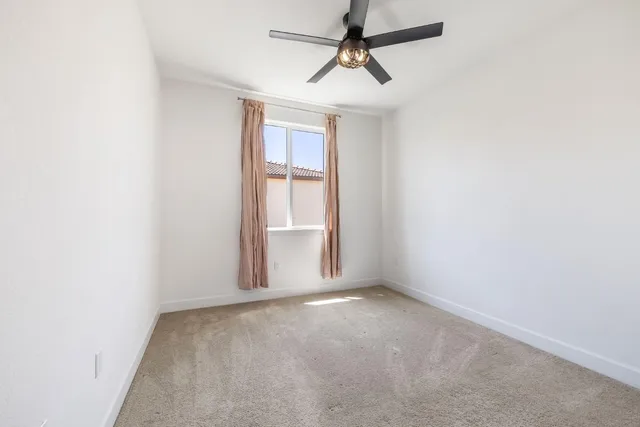 a bedroom with a bed a couch and a window