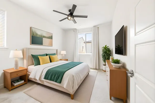 a bedroom with a large bed and a chandelier