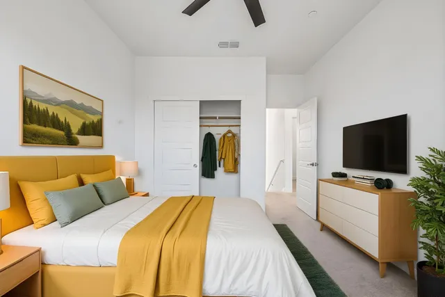 a view of a livingroom with a ceiling fan and window