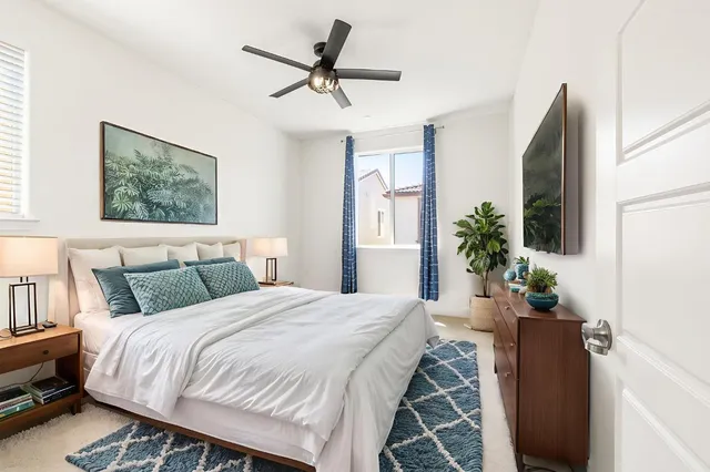 a large bedroom with a bed and a large window