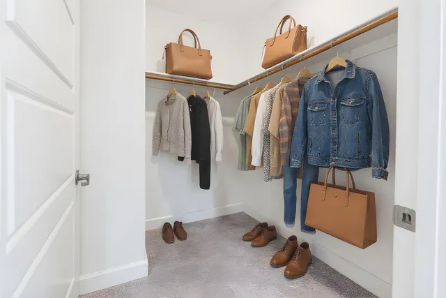 a view of hallway with walk in closet and bathroom