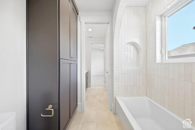 4092 Discovery Way Park City, UT 84098 - Photo 39 of 66 Built-in dark cabinetry, recessed lighting, tiled flooring, white subway tile wall surround, and a built-in tub with an arched tiled niche