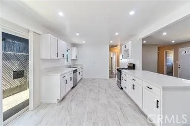 a large kitchen with stainless steel appliances lots of counter top space