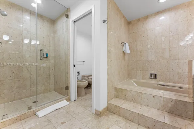 a bathroom with a bathtub and a shower