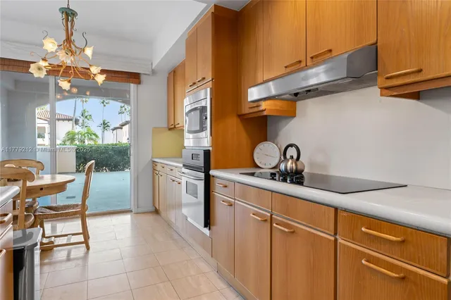 a kitchen with stainless steel appliances a stove microwave and refrigerator