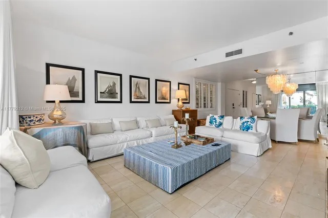 a living room with furniture and a painting on the wall