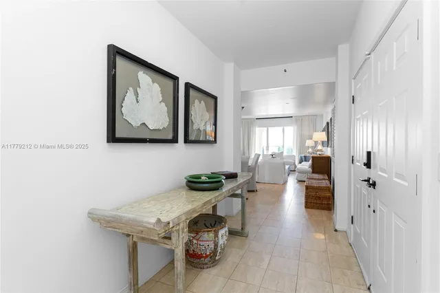 a view of an entryway with wooden floor and a living room