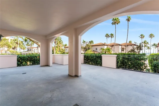 a view of an empty room with a windows and fireplace