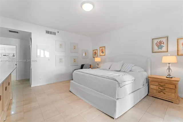 a bedroom with a bed and a lamp