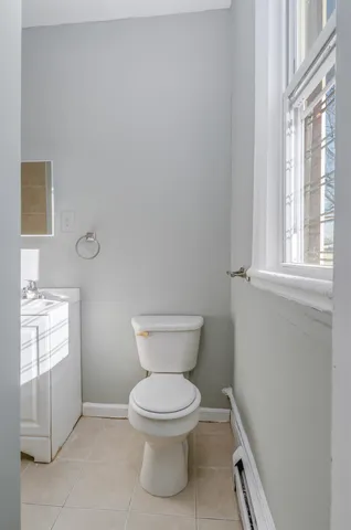 a bathroom with a toilet sink and window