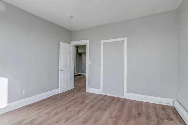 a view of an empty room and wooden floor
