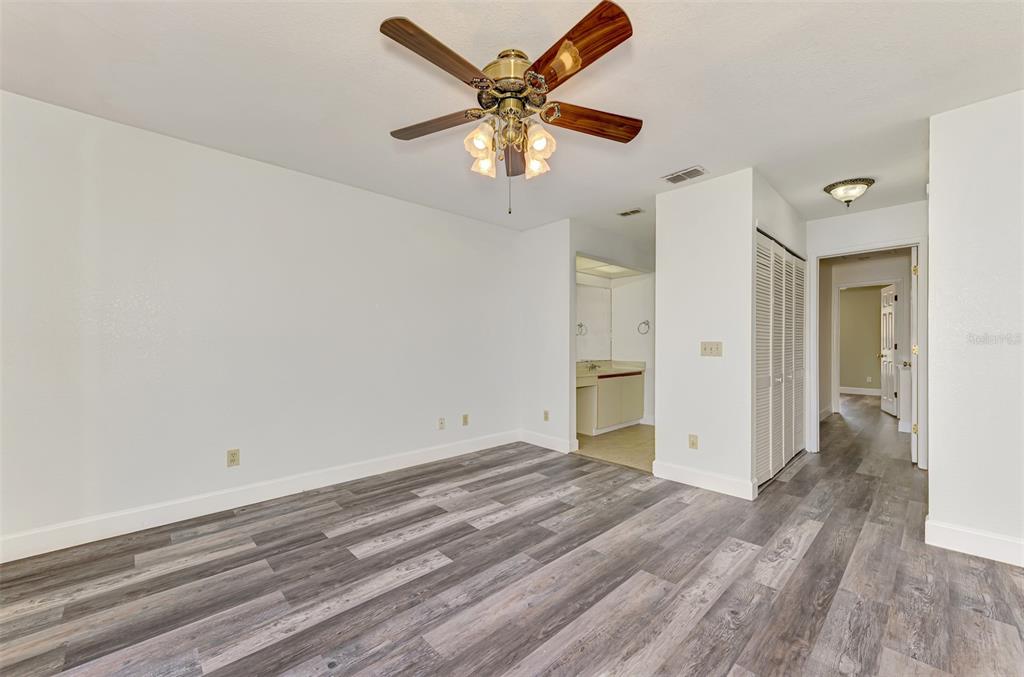 26310 Rampart Boulevard, Unit 505/E Punta Gorda, FL 33983 - Photo 24 of 64 wooden floor in an empty room
