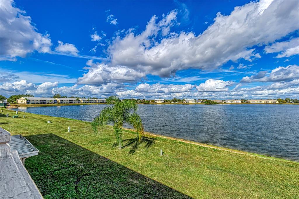 26310 Rampart Boulevard, Unit 505/E Punta Gorda, FL 33983 - Photo 30 of 64 a view of a lake with a big yard