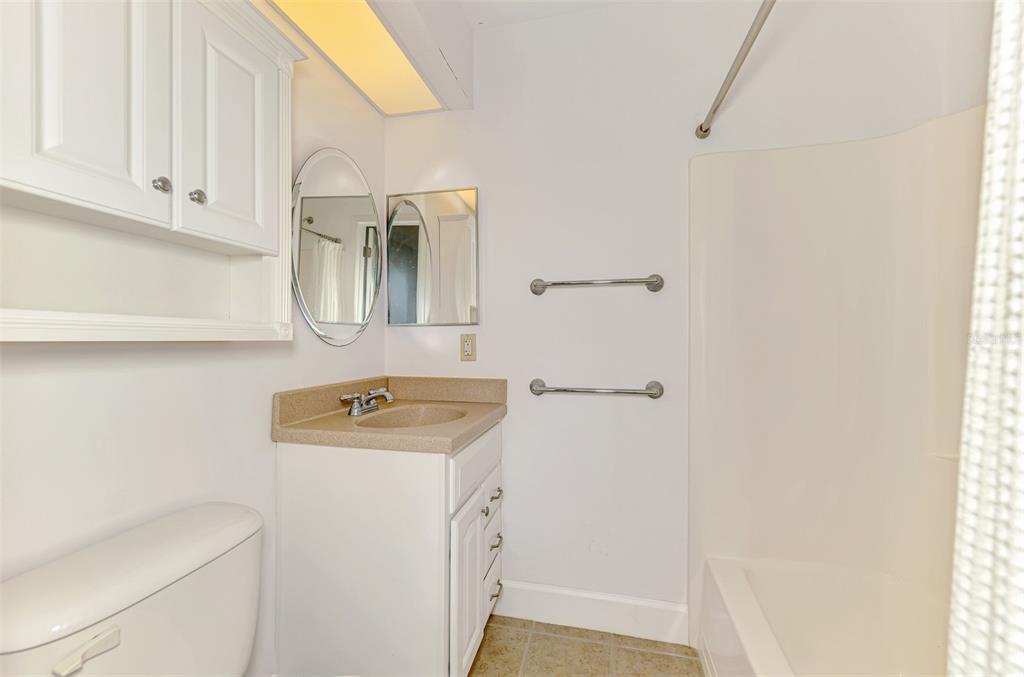 26310 Rampart Boulevard, Unit 505/E Punta Gorda, FL 33983 - Photo 34 of 64 a bathroom with a sink and a washer dryer