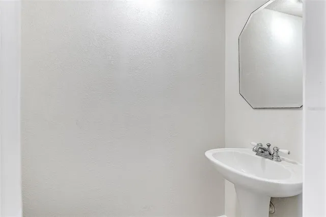 a aerial view of a swimming pool with lawn chairs