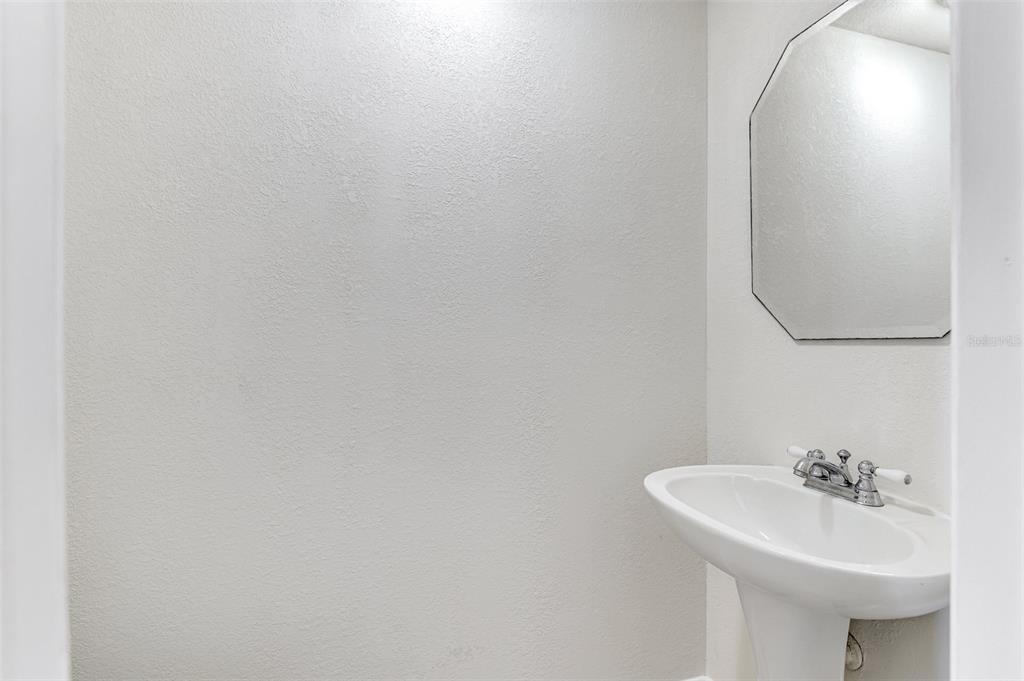 26310 Rampart Boulevard, Unit 505/E Punta Gorda, FL 33983 - Photo 36 of 64 a bathroom with a sink and mirror