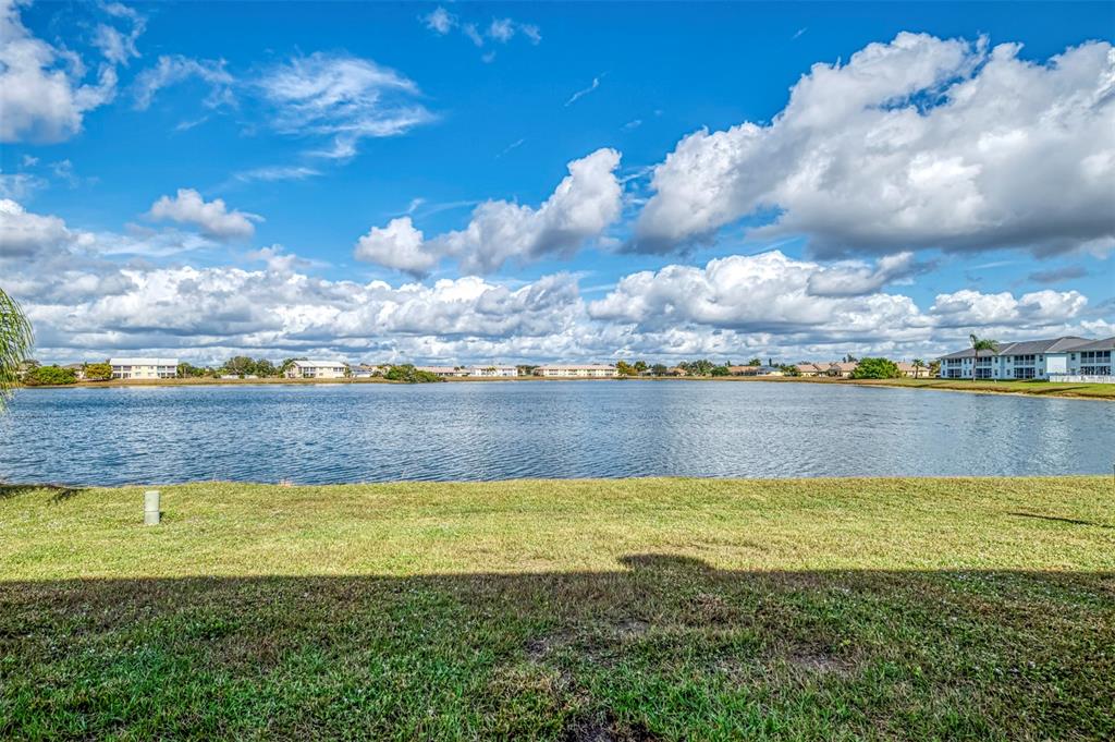 26310 Rampart Boulevard, Unit 505/E Punta Gorda, FL 33983 - Photo 46 of 64 a view of a lake with houses in the back