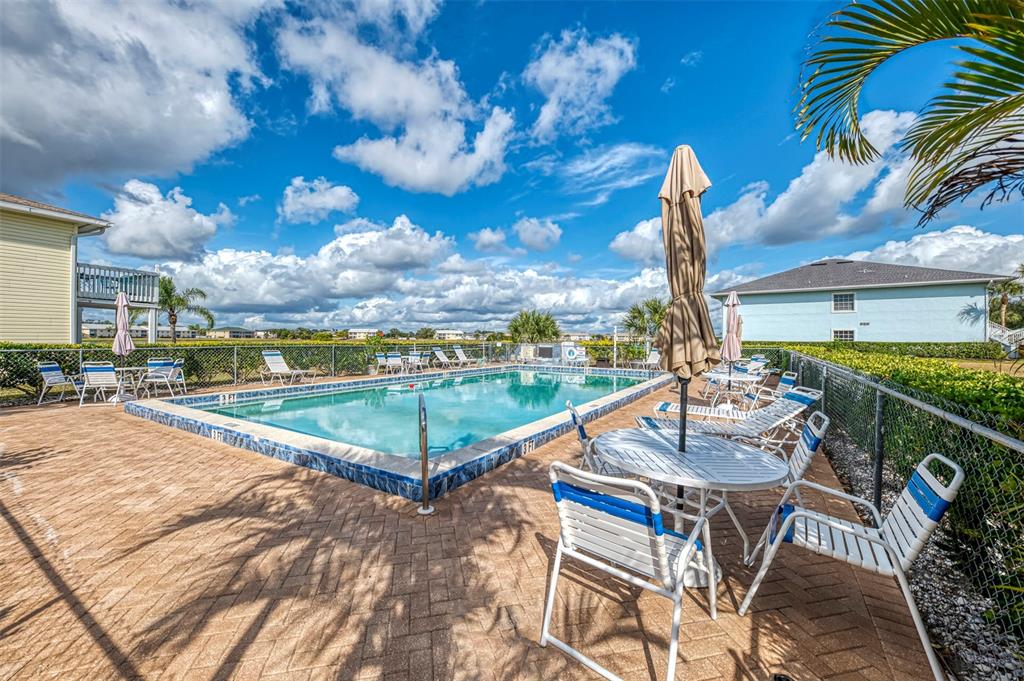 26310 Rampart Boulevard, Unit 505/E Punta Gorda, FL 33983 - Photo 56 of 64 a view of swimming pool with outdoor seating and city view