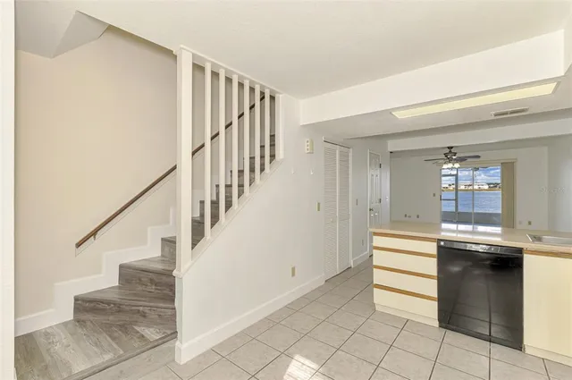a kitchen with a sink a refrigerator and cabinets