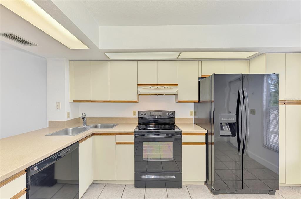26310 Rampart Boulevard, Unit 505/E Punta Gorda, FL 33983 - Photo 7 of 64 a kitchen with a refrigerator sink and stove
