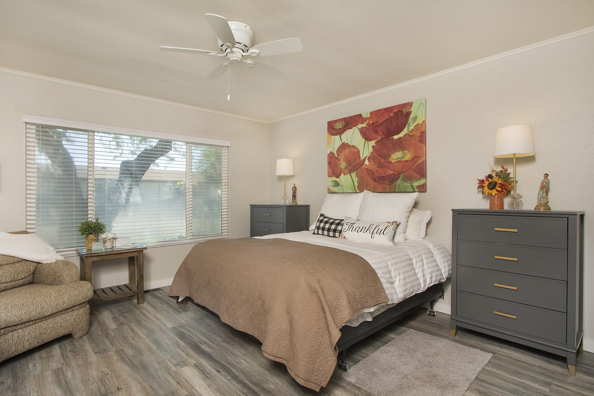74986 Conestoga Thousand Palms, CA 92276 - Photo 12 of 29 a bedroom with a large bed and a painting on the wall