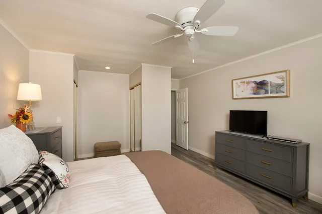 a bedroom with a bed and a flat screen tv