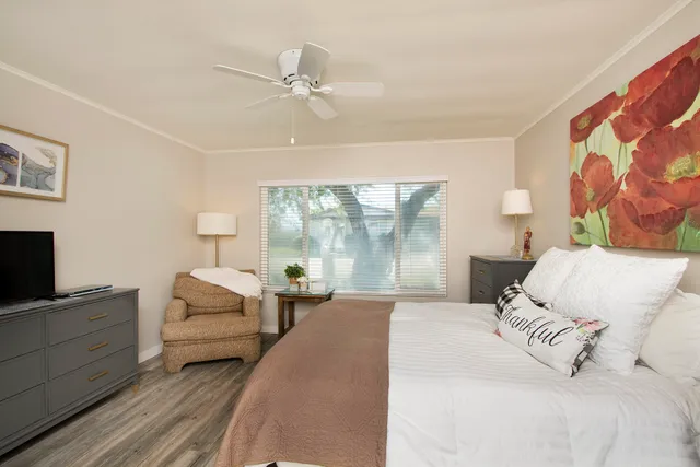 a bedroom with a large bed and a window