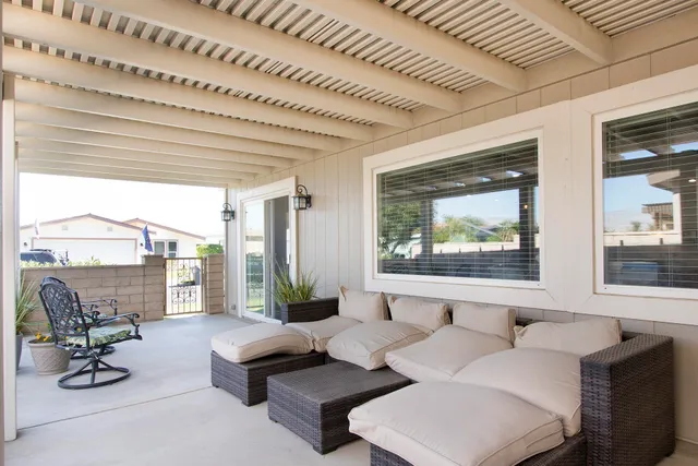 a living room with furniture and floor to ceiling windows