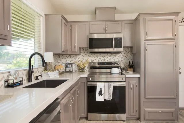 a kitchen with a sink stove and refrigerator