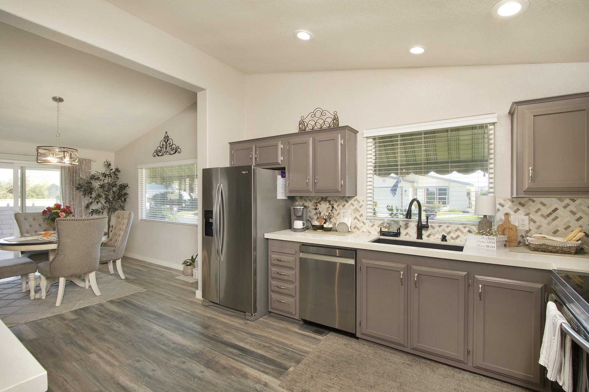 74986 Conestoga Thousand Palms, CA 92276 - Photo 7 of 29 a kitchen with stainless steel appliances a sink cabinets and wooden floor