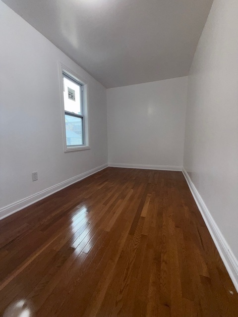 1620 West 44th Street Chicago, IL 60609 - Photo 8 of 37 an empty room with wooden floor and windows