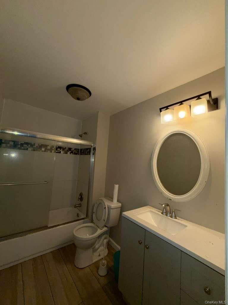 27 Panamoka Trail Ridge, NY 11961 - Photo 2 of 9 a bathroom with a sink mirror vanity and toilet