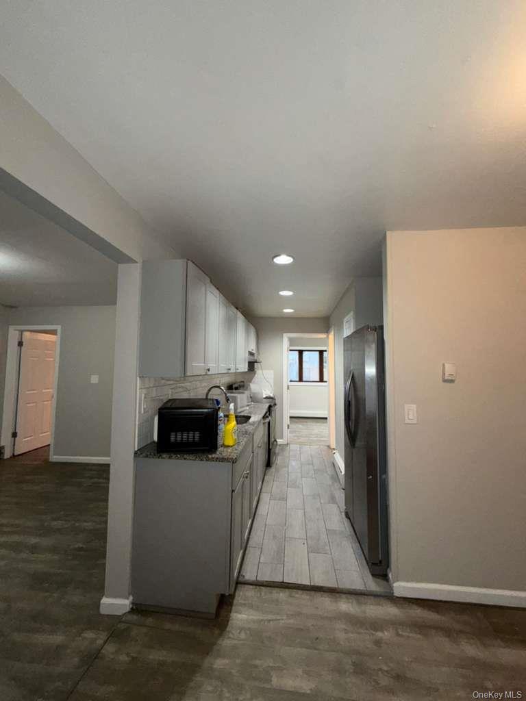 27 Panamoka Trail Ridge, NY 11961 - Photo 6 of 9 a view of a kitchen with cabinets stainless steel appliances and a counter top space