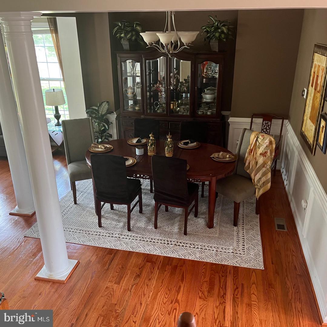 17696 Possum Point Road Dumfries, VA 22026 - Photo 7 of 45 a dining room with furniture a rug and wooden floor